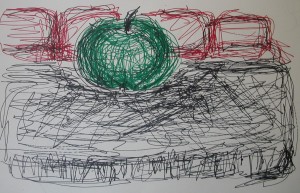 Apple on table with sofa behind it